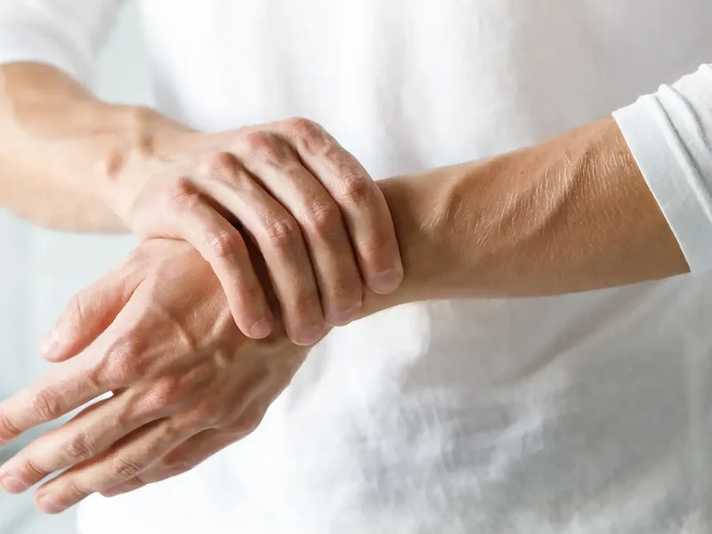 Physical therapist assessing a patient's joint mobility and strength for arthritis