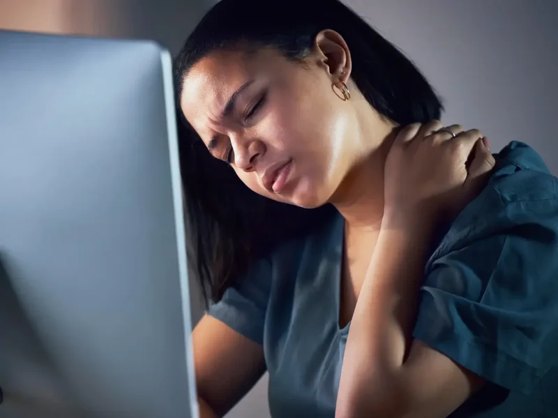 Physical therapist assessing a patient's movement patterns for chronic pain