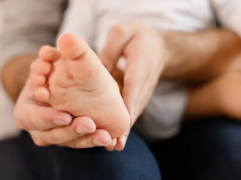 Physical therapist assessing a patient's foot and ankle movement and mobility