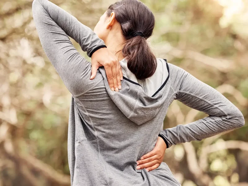 Physical therapist assessing a patient's low back movement and mobility