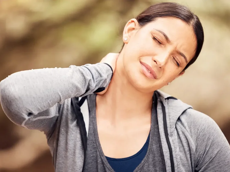 Physical therapist assessing a patient's neck movement and mobility