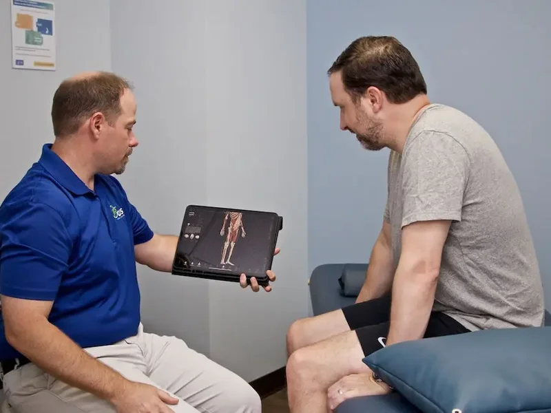 Physical therapist guiding a stroke recovery patient through balance and mobility exercises