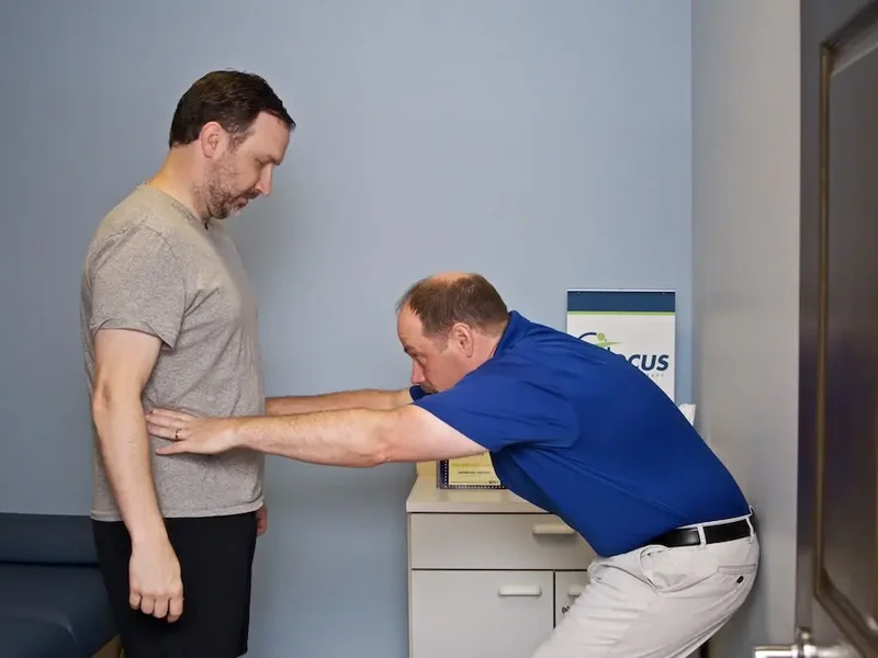 Patient performing progressive strength training under supervision